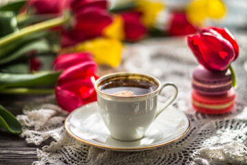 Obraz na płótnie Canvas cup of coffee and tulips