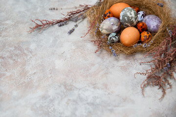 Easter eggs with marble pattern on a gray stone table. Eco-friendly natural dyes for eggs. Copy space