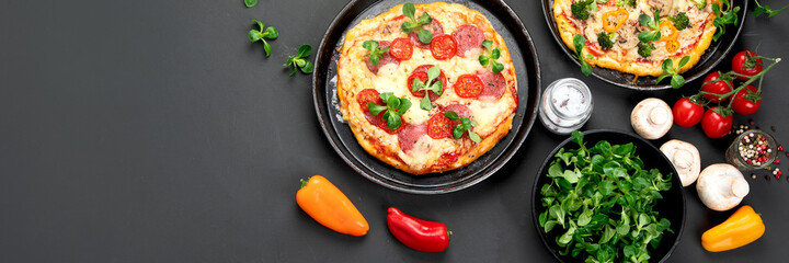 Delicious fresh pizzas variety with different souces and vegetables. Homemade food concept.