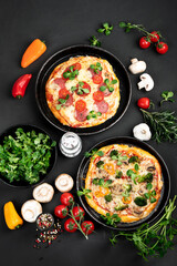 Delicious fresh pizzas variety with different souces and vegetables. Homemade food concept.