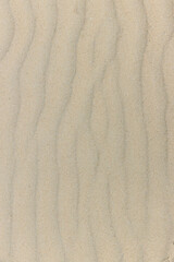 Fototapeta na wymiar Natural sand stone texture background. sand on the beach as background. Wavy sand background for summer designs.