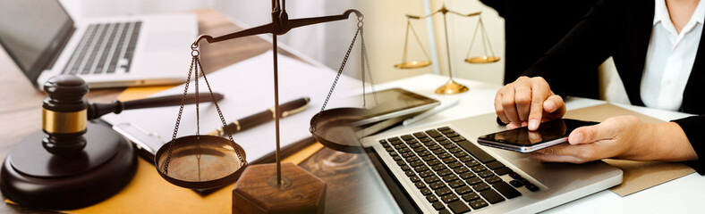 Business and lawyers discussing contract papers with brass scale on desk in office. Law, legal services, advice, justice and law concept picture with film grain effect