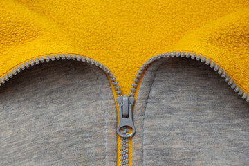 The color concept of 2021. The fabric is yellow and gray. The zipper for sewing is gray. © Vancouver