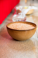 brown bowl with raw wheaten in a church on the floor