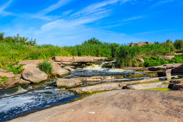 Fototapeta na wymiar View of Tokovsky waterfalls on the Kamenka river in Dnipropetrovsk region, Ukraine
