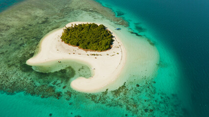 Tropical island with sandy beach by atoll with coral reef and blue sea, aerial view. Patawan island with sandy beach. Summer and travel vacation concept.
