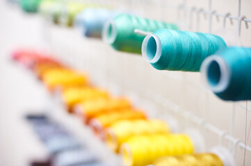 Closeup Colorful Spool of Thread on the Sewing Equipment, Fabric and Textile Industry, Embroidery...