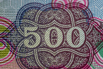 Macro view of 500 dirham united arab emirate purple bank note or bill. Selective Focus top view.