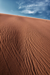 Sand dune under a beautiful vivid blue sky with feathery clouds, Valle de la Luna, Atacama desert, Chile
