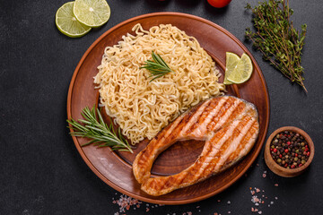Fresh cooked delicious salmon steak with spices and herbs baked on a grill
