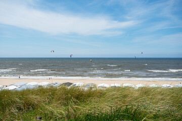 empty sandy beach. kite surfers on the water of North Sea, Zandvoort, Netherlands
