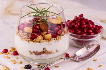Dessert with cream cheese with granola and pomegranate.