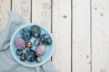 Easter eggs with space pattern. Coloration of eggs with natural dyes of blue, purple color. Copy space