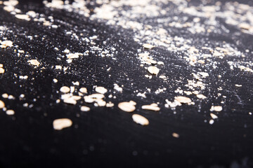 oatmeal powder on black plate slate