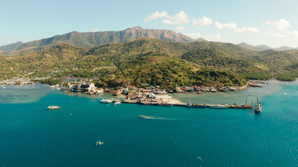 Fototapeta premium Ferry port in the city of Coron, on the island Busuanga, Philippines. Passenger and cargo port with ships. Ferries transport vehicles and passengers in port