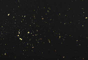 Gold flakes of potal on black textured paper - obrazy, fototapety, plakaty