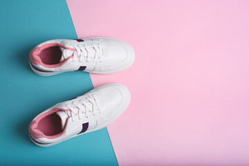 Flat lay of sport sneakers shoes on the blue and pink background. Fitness background. Healthy...