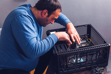 the man cleans the dusty computer