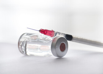 a vial containing clear fluid is shown with a syringe