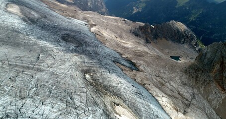 The Marmolada glacier in summer: Aerial view of the last and the only glacier of the Dolomites, UNESCO heritage, near the town of Canazei - August 2018 - Evidence of global warming and melting glacier