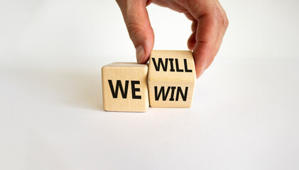 We will win symbol. Businessman turns cubes and changes words we will to we win. Beautiful white...