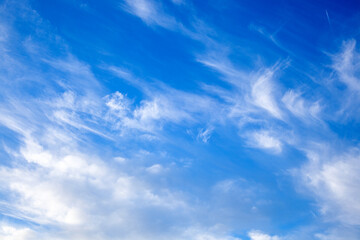 blue sky with clouds from below, high flying passenger plane with condensation trail. jet plane...