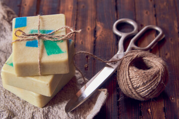Fototapeta na wymiar A fragrant organic handmade soap with a geometric pattern and packaging items.
