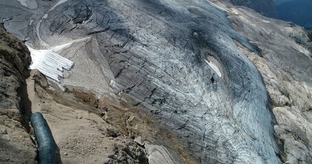 The Marmolada glacier in summer: Aerial view of the last and the only glacier of the Dolomites, UNESCO heritage, near the town of Canazei - August 2018 - Evidence of global warming and melting glacier