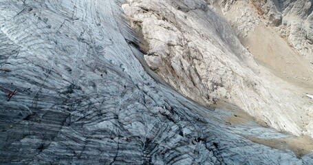 The Marmolada glacier in summer: Aerial view of the last and the only glacier of the Dolomites, UNESCO heritage, near the town of Canazei - August 2018 - Evidence of global warming and melting glacier