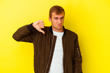 Young caucasian man isolated on yellow background