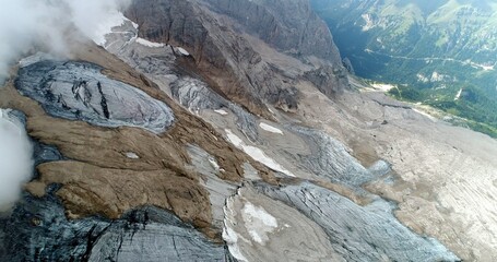 The Marmolada glacier in summer: Aerial view of the last and the only glacier of the Dolomites, UNESCO heritage, near the town of Canazei - August 2018 - Evidence of global warming and melting glacier
