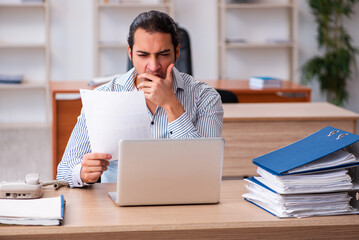 Young male employee sitting in the office