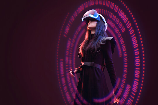 Woman on dark virtual reality background. Female using VR helmet. Augmented reality, future technology, game concept. Purple neon light. Futuristic holographic interface to display data.