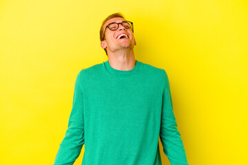 Young caucasian man isolated on yellow background