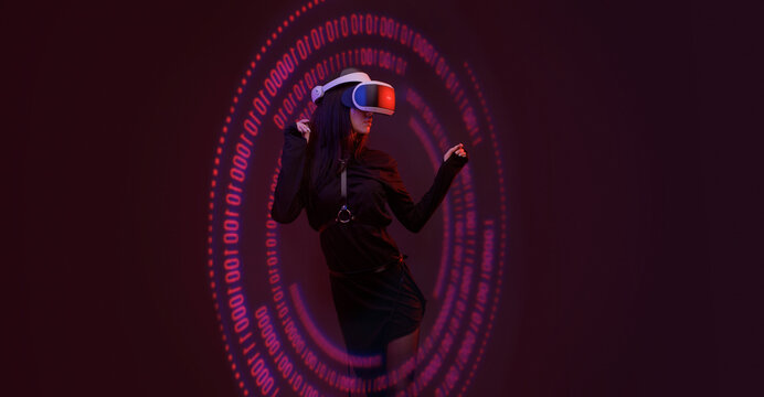 Woman on dark virtual reality background. Female using VR helmet. Augmented reality, future technology, game concept. Purple neon light. Futuristic holographic interface to display data. - Powered by Adobe