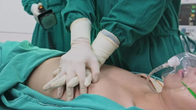 Group of Asian professional surgeons and nurses team making CPR.