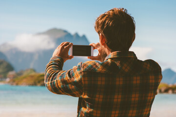 Traveler man taking photo by smartphone camera traveling alone blogger influencer outdoor summer...