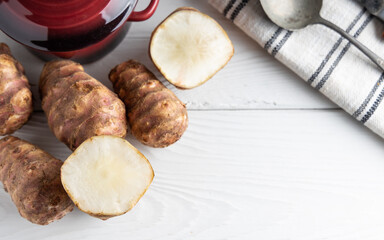 Trendy Winter vegetable. Jerusalem artichoke one of the forgotten vegetables who has become trendy again, on a white background.