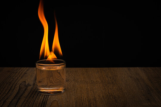 Small glass of liquor with fire