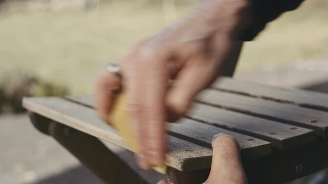 Carpenter Sanding Down Edge Of Chair