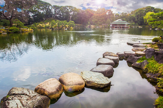 Amazing view of the stone path in the lake water of Kiyosumi teien park . Time of sakura - end of March!