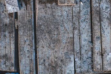 Dirty very old cracked wood plank, vintage wood background with knocked down planks close-up, rough surface, weathering.