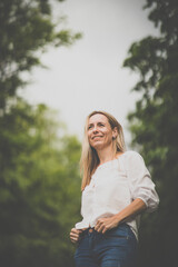 Obraz premium Portrait of a relaxed middle aged woman outdoors, looking happy, enjoying the life