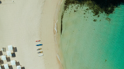 Tropical beach with sun beds near the lagoon with turquoise water Boracay, Philippines, aerial...