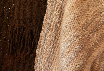 Closeup of handmade sustainable cloths, eco friendly fabric, brown and beige scarfs as backdrop