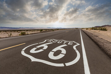Route 66 highway sign with dawn sky near Amboy in the California Mojave desert.  