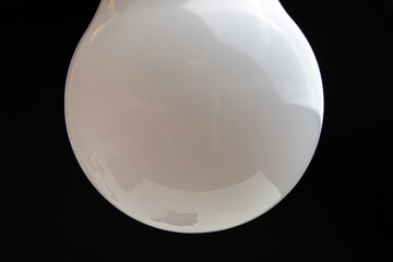 a white light bulb on dark background