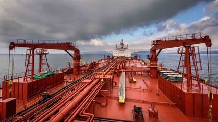 View of a super tanker from forward to aft between two deck hose handling cranes