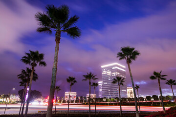 Twilight evening view of traffic streaming by the downtown skyline of Irvine, California, USA.