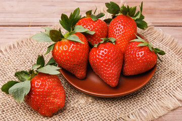 Fresh red strawberries on a wooden board